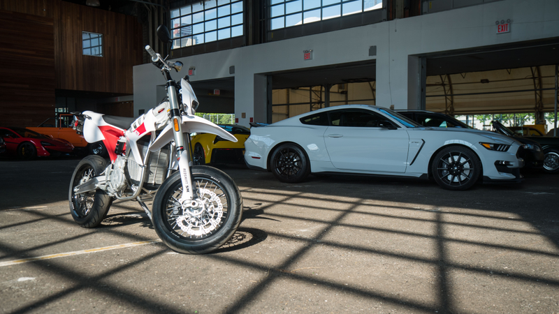 The Red Shift SM parked next to CCC’s new Ford Shelby Mustang GT350.